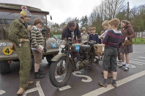 There's a war on, and pupils and teachers can see some of the military vehicles of the time